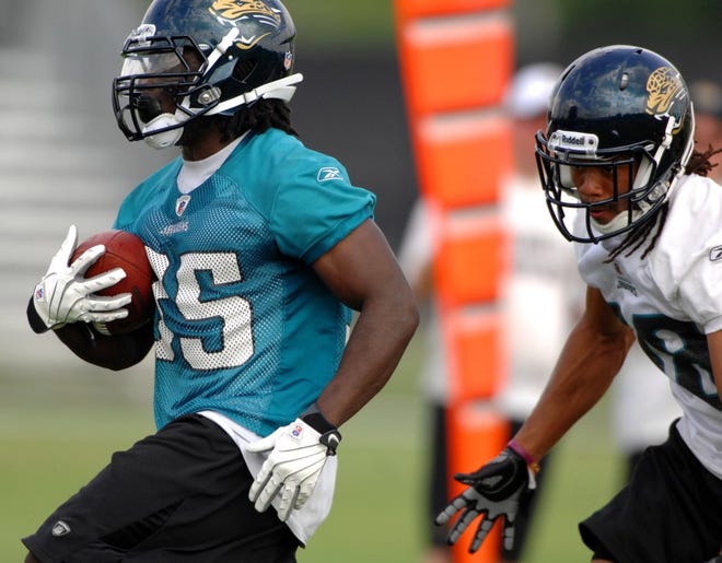 Jaguars rookie running back Deji Karim outruns defensive back Josh Gordy to the end zone during Monday's minicamp practice session.