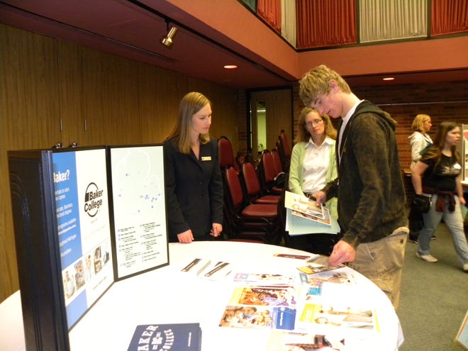 Julie Groesser (far left) shows Jordan Dieterle, a junior at Reading High School about programs available at Baker College. Transition team member Tammy Ryan is also in the photo. The college was at the transition conference at Hillsdale College's Dow Center Tuesday, April 27, 2010.
