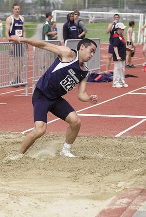 Monika O’Clair/Foster’s Daily Democrat 
UNH’s Anthony Vorachak lands his triple jump at the America East outdoor track championship in Durham Sunday.