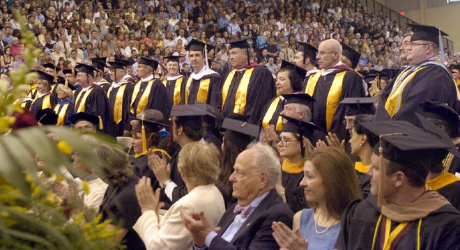 To celebrate Walsh University’s 50th anniversary, a graduate from each of the first 46 graduating classes (1964-2009) led this year’s graduation processional.