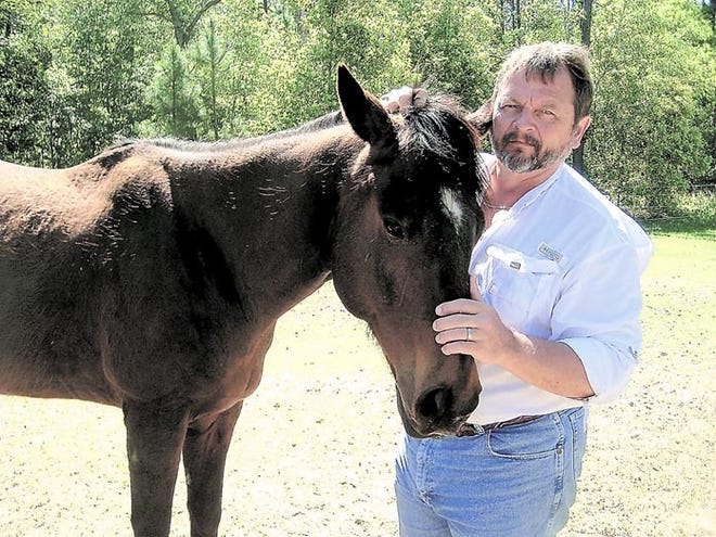 Ric Lehman, Haven Horse Ranch owner, stands on his acres of land with his