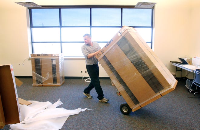 Jeremy Spires of Midwest Office Supply wheels a filing cabinet into an office at Erin's Pavilion at Southwind Park on Wednesday, March 17, 2010. The pavillion should be open in late May or early June. Ted Schurter/The State Journal-Register