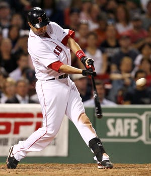 Mike Lowell hits a two-run double during the third inning of a Monday's game against the Los Angeles Angels at Fenway Park.