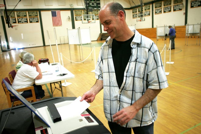 Mike Condry of Upton casts his ballot Tuesday during the annual town election at Nipmuc Regional High School.