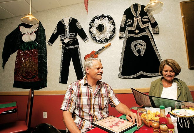 Photo by Daniel Freel/New Jersey Herald
 Mike and Vicki Porter, of Budd Lake, look over the menu at Salsa in Newton Tuesday. As of Sunday night, the Mexican-themed restaurant was booked for Cinco de Mayo.