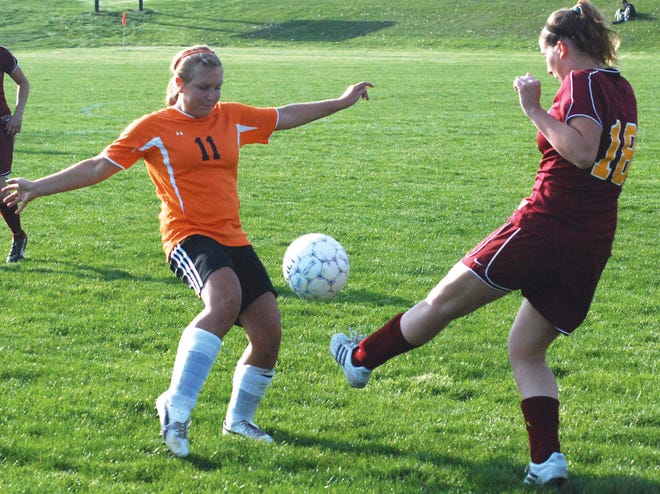 Putting up a wall: Washington senior defender Kirsten Tervo, No. 11, stops an East Peoria girls soccer player April 20 during a Mid-Illini Conference match. The Lady Panthers host Morton Thursday.
