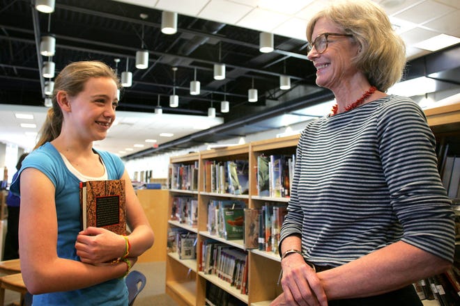 Emily Langmeyer, 11, a sixth-grade student at Horace Mann Middle School in Franklin, chats with children's author Janet Taylor Lisle, Wednesday in the school's library about her favorite book, from Lisle, " The Crying Rocks" which Langmeyer is seen holding. Lisle visited the school to talk with her young fans and answer questions about her books. Lisle was surprised to find out while talking to Langmeyer who is a big fan of the author, that she had read all of Lisle's 12 books.