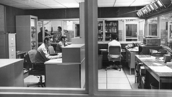Dispatchers work in the control center of the old police building in 1971.