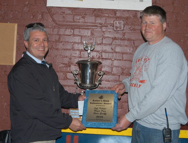 Steve Ewing, left, and Jeff Killips, right, accept the Gordon W. Malcolm Memorial Trophy and recognition as the Sault Sportsmen of the Year during an open house Thursday at Kaine’s Rink. Roger Parr, not pictured, was also honored along with Ewing and Killips.