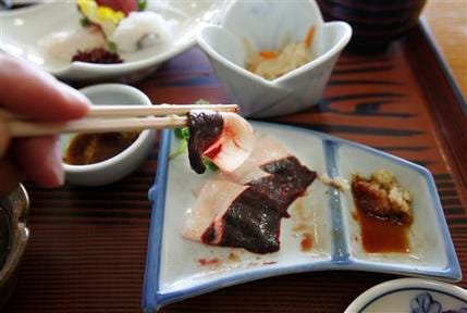 Dolphin sashimi, raw slices from the breast of a striped dolphin, is served during lunch at Moby Dick, a hotel run by the local government, in Taiji, southwestern Japan, Sunday, May 9, 2010.