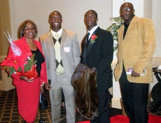 Devin McCourty (in dark suit), the Patriots' top draft pick in April, poses with his mother, Phyllis Harrell, and his twin brother Jason (second from left) in 2008 at a Rutgers University football banquet.