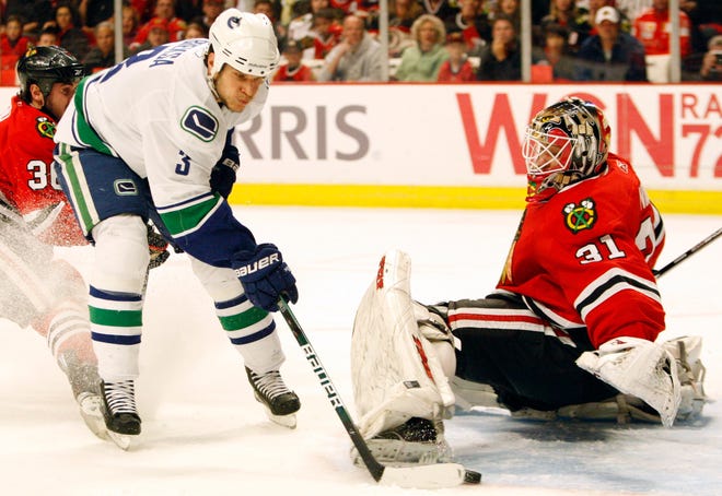 Vancouver Canucks' Kevin Bieksa (3) scores against Chicago Blackhawks goalie Antti Niemi during the first period of Game 5 of an NHL hockey Western Conference second-round playoff series Sunday, May 9, 2010, in Chicago.(AP Photo/Nam Y. Huh)
