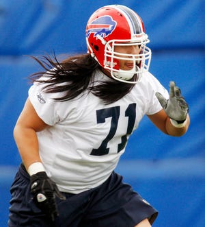 In this photo taken on May 7, 2010, Buffalo Bills' Ed Wang runs a drill during NFL football mini-camp in Orchard Park, N.Y. Wang is the first player with direct Chinese ancestry to be selected in the NFL draft, chosen by the Buffalo Bills out of Virginia Tech in the fifth round. (AP Photo/David Duprey)
