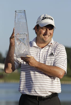 Tim Clark of South Africa holds The Players Championship trophy on Sunday.