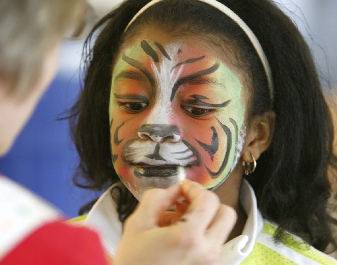 Kayla Pierce, 10, has her face painted by artist Marjorie Funk during the 21st annual “Celebrating the Family” Fair, organized by FACES of Stark County on Sunday afternoon at Timken High School in Canton.
