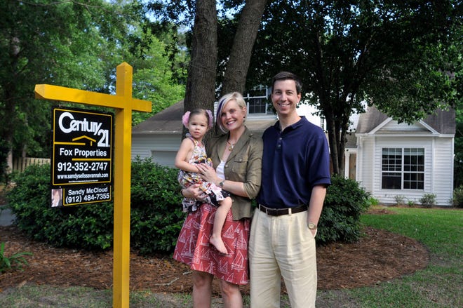 Liz and Karl Stephens with their daughter Sterling in front of their house on Brompton Road. (Steve Bisson/Savannah Morning News)