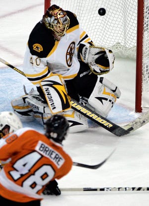 Philadelphia Flyers center Danny Briere, front, fires the puck past Boston Bruins goalie Tuukka Rask in the second period of Game 6.