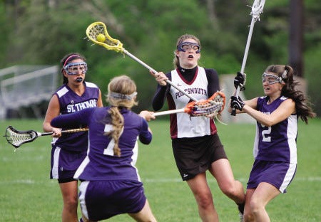 Portsmouth High School’s Callie Aspinwall (center) fires a shot while under pressure from St. Thomas defenders Taylor Midgley (7) and Sarah Fortin (2) during the Clippers’ 10-9 Division II win over the Saints in Portsmouth on Wednesday.