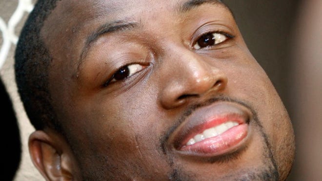 Dwyane Wade listens to a reporter's question at the Heat's post-season wrap-up in Miami.