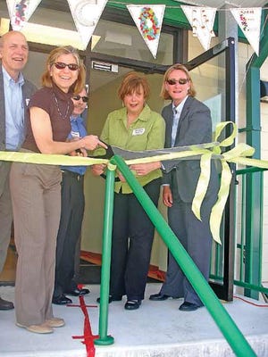 The Birchtree Center's board of directors ceremoniously cut the ribbon of its new location in Newington. From left, Bruce Dicker, Glicka Kaplan (holding the scissors), Gregory Majewski, Christine Guarino and Tracey Tucker.