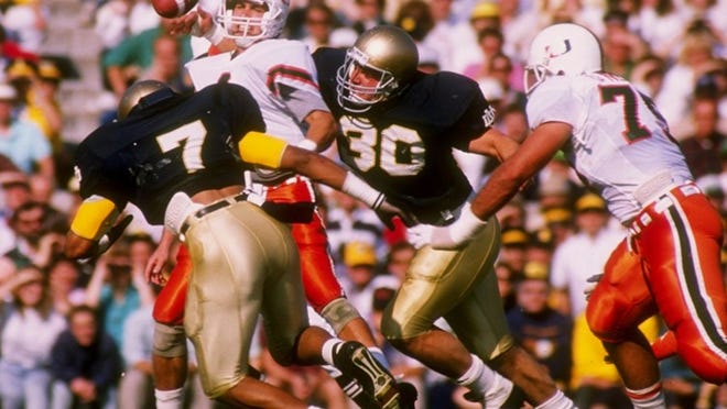 'Canes quarterback Steve Walsh tries to escape the Notre Dame defense in the teams' 1988 meeting in South Bend, Indiana. Notre Dame won the game 31-30.