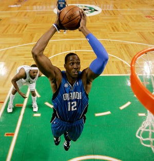 Orlando Magic's Dwight Howard goes in for the dunk in front of Boston Celtics' Paul Pierce during Orlando's 101-82 win in Game 7 of an NBA Eastern Conference semifinal basketball series in Boston on Sunday, May 17, 2009. (AP Photo/Winslow Townson)