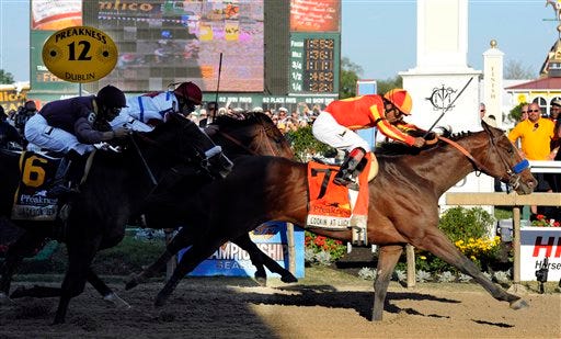 Lookin At Lucky (7), with Martin Garcia aboard, moves over the finish line to win the 135th Preakness horse race at Pimlico Race Course, Saturday, May 15, 2010, in Baltimore.