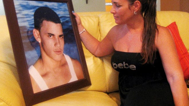 ay 13, 2010 - Jacquelyn Quiroga, 37, with a picture of her son Jorge Gonzalez, 20, who was killed in a gang-related shooting on April 25. Police have arrested two men and charged them with first-degree murder.