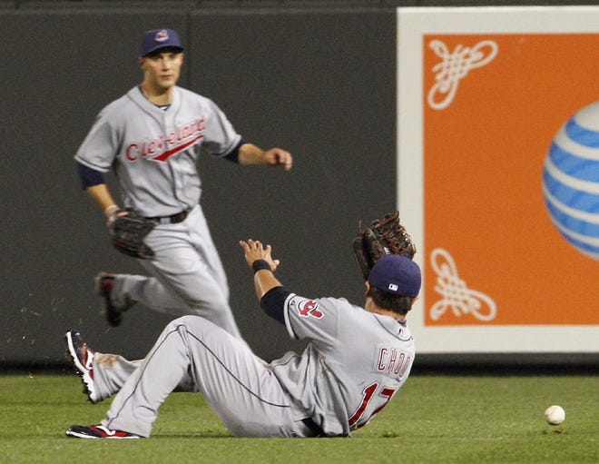 Cleveland right fielder Shin-Soo Choo (front) cannot stop a single by Baltimore's Corey Patterson as Indians center fielder Grady Sizemore tries to back him up during the third inning of a baseball game in Baltimore on Friday.