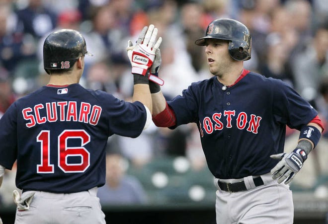 Boston’s Dustin Pedroia, right, is congratulated by teammate Marco Scutaro after hitting a two-run homer in the first inning.