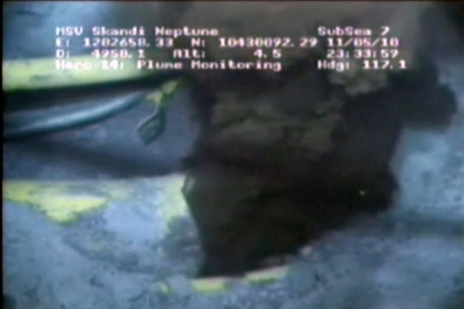 This image from a video released by BP PLC shows oil spewing from a yellowish, broken pipe 5,000 feet below the surface. The oil looks like steam rushing from a geyser. The video released Wednesday gives a not-yet-seen glimpse of the leaking well a mile underwater. The stream occasionally can be seen becoming lighter as natural gas mixes into the gusher.