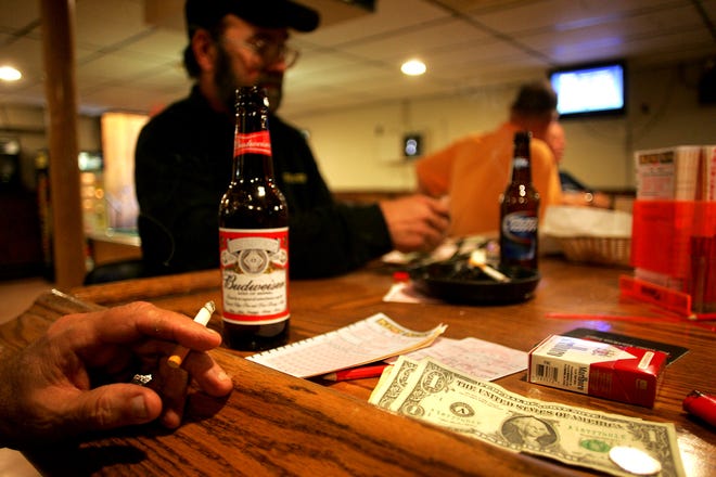 Milford is imposing a townwide ban on smoking in private clubs. Pictured, club members at the Italian American War Veterans Club Post 40 in Milford are still enjoying their right to smoke in their private club Monday. The ban starts July 1.