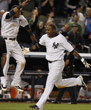 Yankees second baseman Robinson Cano (left) leaps as Marcus Thames nears home plate after hitting a walk-off home run against Red Sox closer Jonathan Papelbon last night.