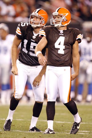 Cleveland kicker Phil Dawson (right) and holder Dave Zastudil watch a kick during a preseason game against Detroit. Dawson has missed four games because of a calf injury, but may be back Sunday.