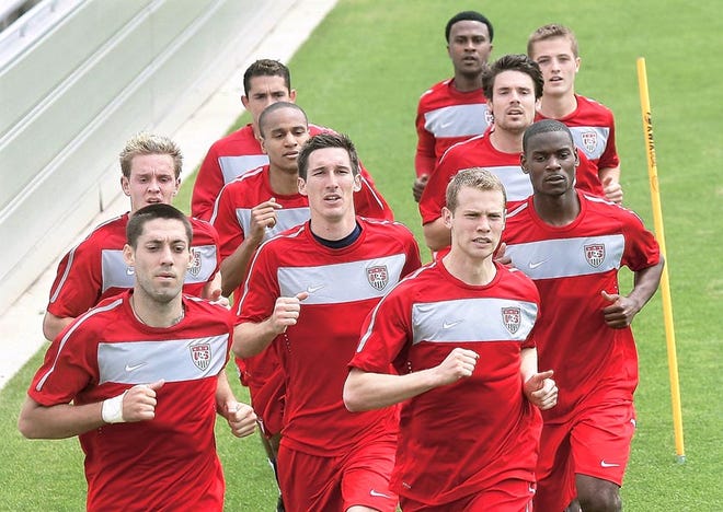 Players Clint Dempsey, left front, Sacha Kljestan, center, and Jonathan Spector, right front, run with other members of the United States Men's National World Cup soccer team on Monday.