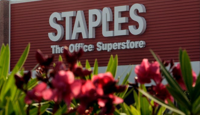 Staples Inc.'s first-quarter net income climbed 30 percent as more customers around the globe bought everything from pens to computers, and sales to small business improved. Above, oleander flowers bloom outside the Staples store in Brandon, Fla.