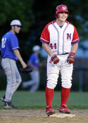 Natick's #44 Brett Farrell is all smiles after hitting a double in Friday night's game with Braintree at Natick H.S.