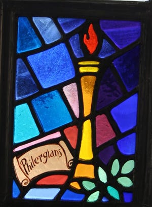 One of the stained glass windows in the new Thayer Academy publication, "Windows To History."
This window was given by and dedicated to the Philergian Society, a local women’s club which celebrated its 100th year of philanthropy and community service in 1999. The club’s seal was designed by Ella Sheppard Gallagher, wife of the Academy’s second headmaster, William Gallagher.
The Philergian window was designed by Harriet Faunce Egan, a 1960 graduate who now lives in Scituate.