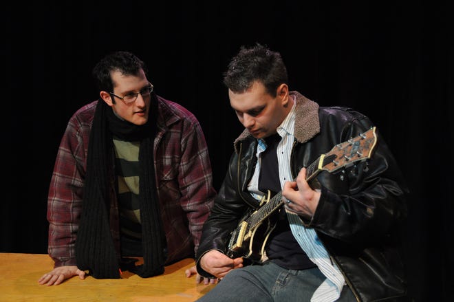 Eric Desnoyers (left) as Mark listens to Michael Foley as Roger playing his guitar in Turtle Lane's "Rent"