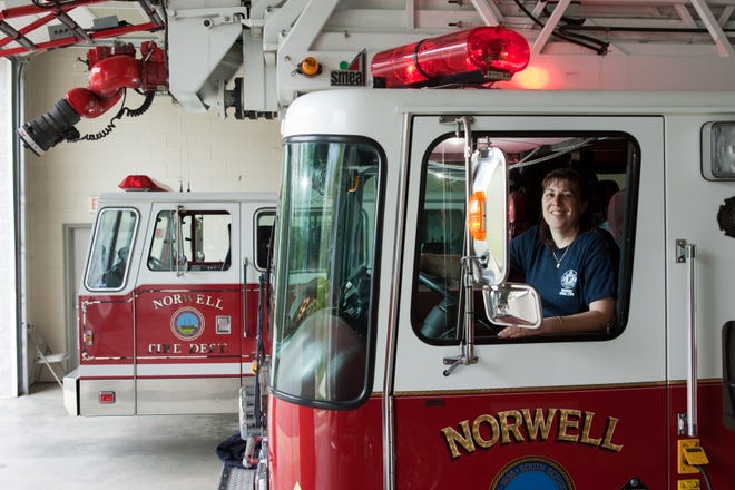 Norwell Firefighter Jeannie Payne sits behind the wheel of Ladder 1. Payne is Norwell’s first and only female firefighter.