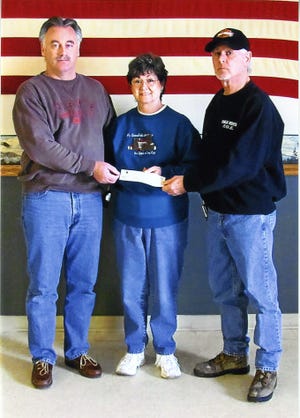 Shown in the picture are at left, Sam Schlubatis, Eagles treasurer; at right, Don Gunterman, Eagles trustee; presenting the check to Jean Milnes, president of BCLC.