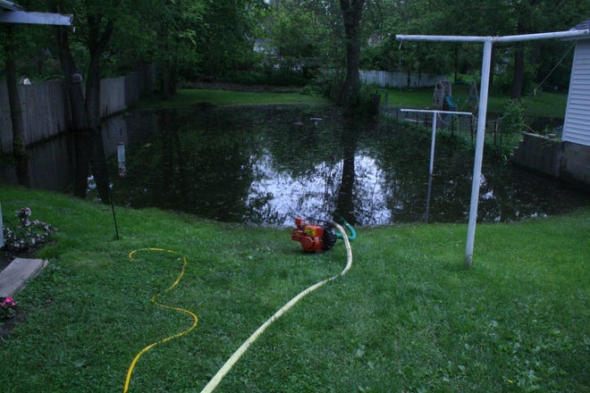 Friday's rainfall turned the backyard of Cindy Suire's 29 S. Norwood Avenue home into a 3-foot deep lake. Suire said with the aid of an industrial water pump, she hopes the water will be removed within the next two days.