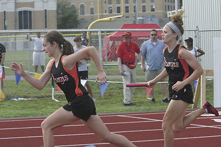 Sturgis’ Emily Roth (right) hands off the baton to Emily Campbell in the 400 relay.