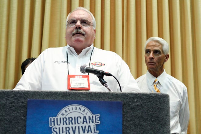 Gov. Charlie Crist, right, listens as Florida Emergency Management Director Dave Halestead speaks to the media about the upcoming hurricane season at the annual Governor's Hurricane conference in Fort Lauderdale, Fla. Thursday, May 27, 2010. He, also, talked about the Gulf oil spill and how it is affecting Florida. (AP Photo/J Pat Carter)
