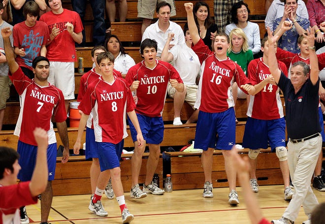 Natick bench celebrates on the last point as they win in Thursday night's volleyball game against Lincoln-Sudbury at Natick High.