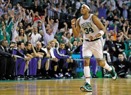 Boston Celtics forward Paul Pierce celebrates a 3-point basket as he runs past the Orlando Magic bench during the fourth quarter of Friday’s Game 6 in the Eastern Conference finals in Boston. Pierce had 31 points and 13 rebounds as the Celtics advanced to the NBA Finals with a 96-84 victory.