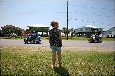Deborah Sevin watching the motorcade in Grand Isle, La., as President Obama arrived nearby in a helicopter.