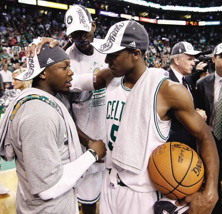 Boston Celtics backup point guard Nate Robinson, left, is congratulated by starting point guard Rajon Rondo, right, and forward Kevin Garnett, rear, after the Celtics beat the Orlando Magic 96-84 in Game 6 of the NBA Eastern Conference finals in Boston on Friday.