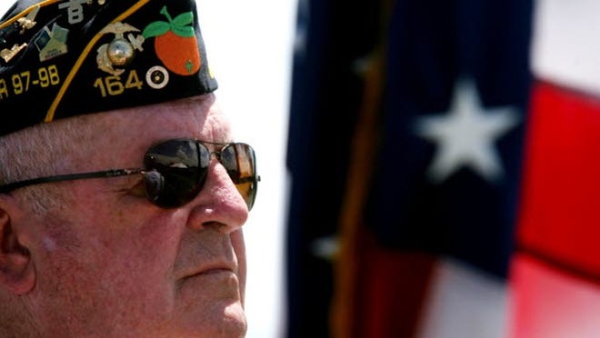 J.J. Farrington of Boynton Beach, a retired Marine from American Legion Post 164 Honor Guard, stands at attention before the closing of the Boynton Veterans' Council Memorial Day Observance at Boynton Beach Memorial Park on Sunday.