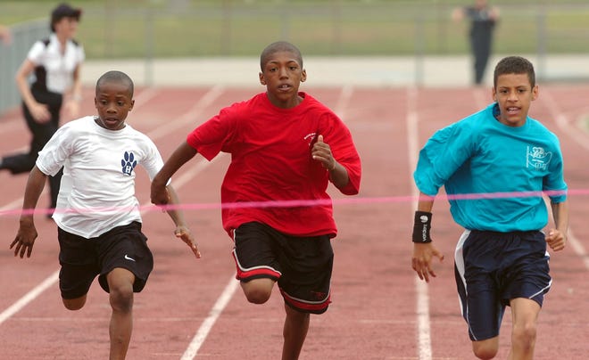 From left, Dejante Starks, 10, Hancock School, Elijah Baker, 12, Davis School, and Matthew Caruso, 11, Arnone School as they compete in the 800 meter race at Brockton Fitness Day.